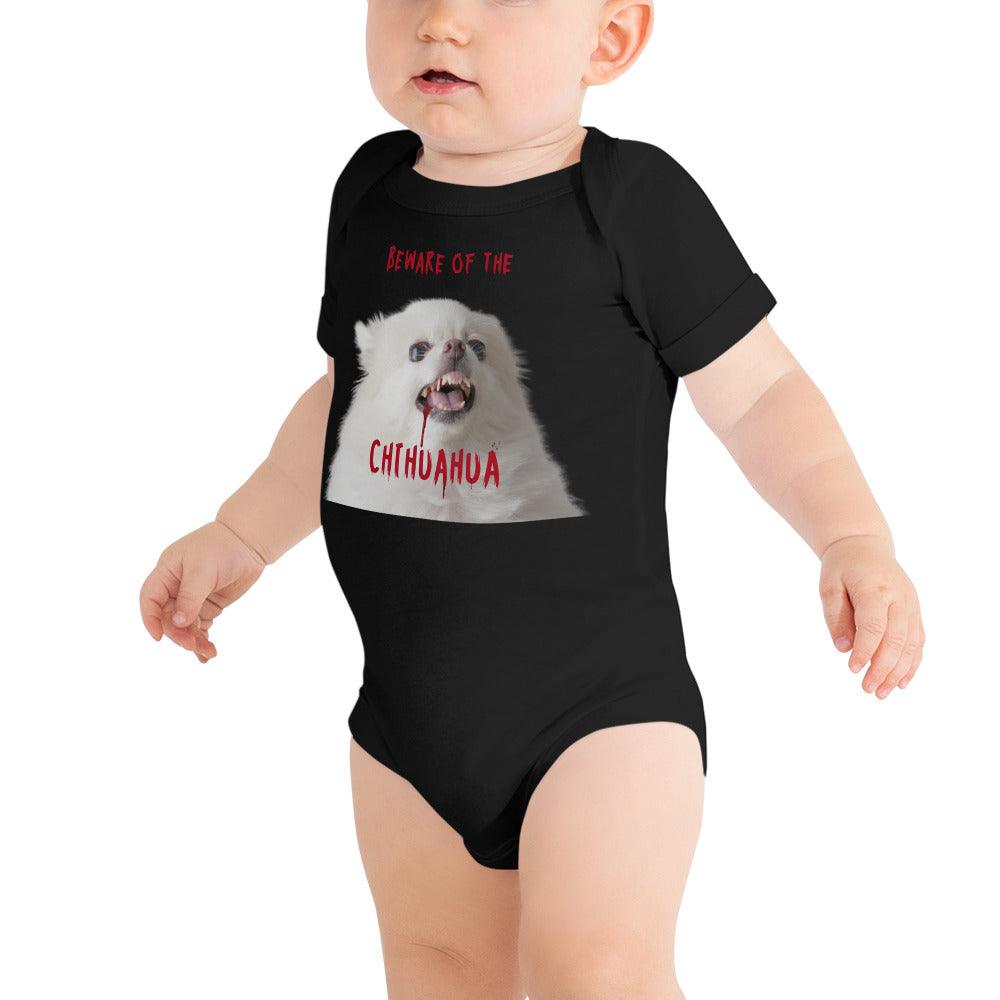 An angelic fluffy white chihuahua with bloody fangs reminds us that looks can be deceiving. Beware of the chihuahua! This black zombie chihuahua baby one piece makes a punky gift for Halloween, or as part of your matching family Halloween t-shirts. Made from 100% cotton. Short sleeves. Sizes 3-6 months, 6-12 months, 12-18 months and 18-24 months. Design by Renate Kriegler for Chimigos.