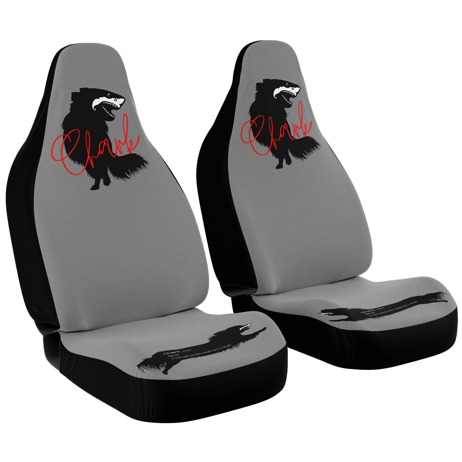 This punky pair of grey front car seat covers feature the silhouette of a black longhair chihuahua with the face of a great white shark - mouth open to show off jaws lined with sharp teeth.  The word "Chark" is artfully placed in red cursive font over the image. The seat fronts feature another shark-faced chihuahua, and a "dictionary entry" of the noun "chark": a chihuahua with teeth like a shark. Design by Renate Kriegler for Chimigos.