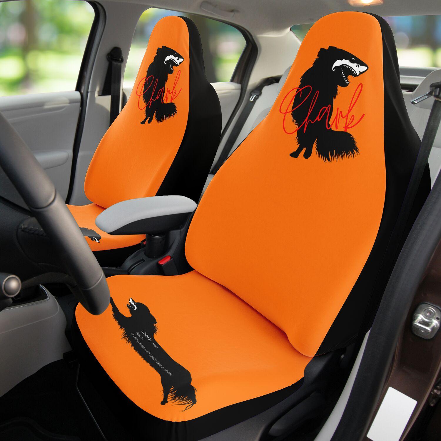 This punky pair of rally orange front car seat covers feature the silhouette of a black longhair chihuahua with the face of a great white shark - mouth open to show off jaws lined with sharp teeth. The word "Chark" is artfully placed in red cursive font over the image. The seat fronts feature another shark-faced chihuahua, and a "dictionary entry" of the noun "chark": a chihuahua with teeth like a shark. Design by Renate Kriegler for Chimigos.