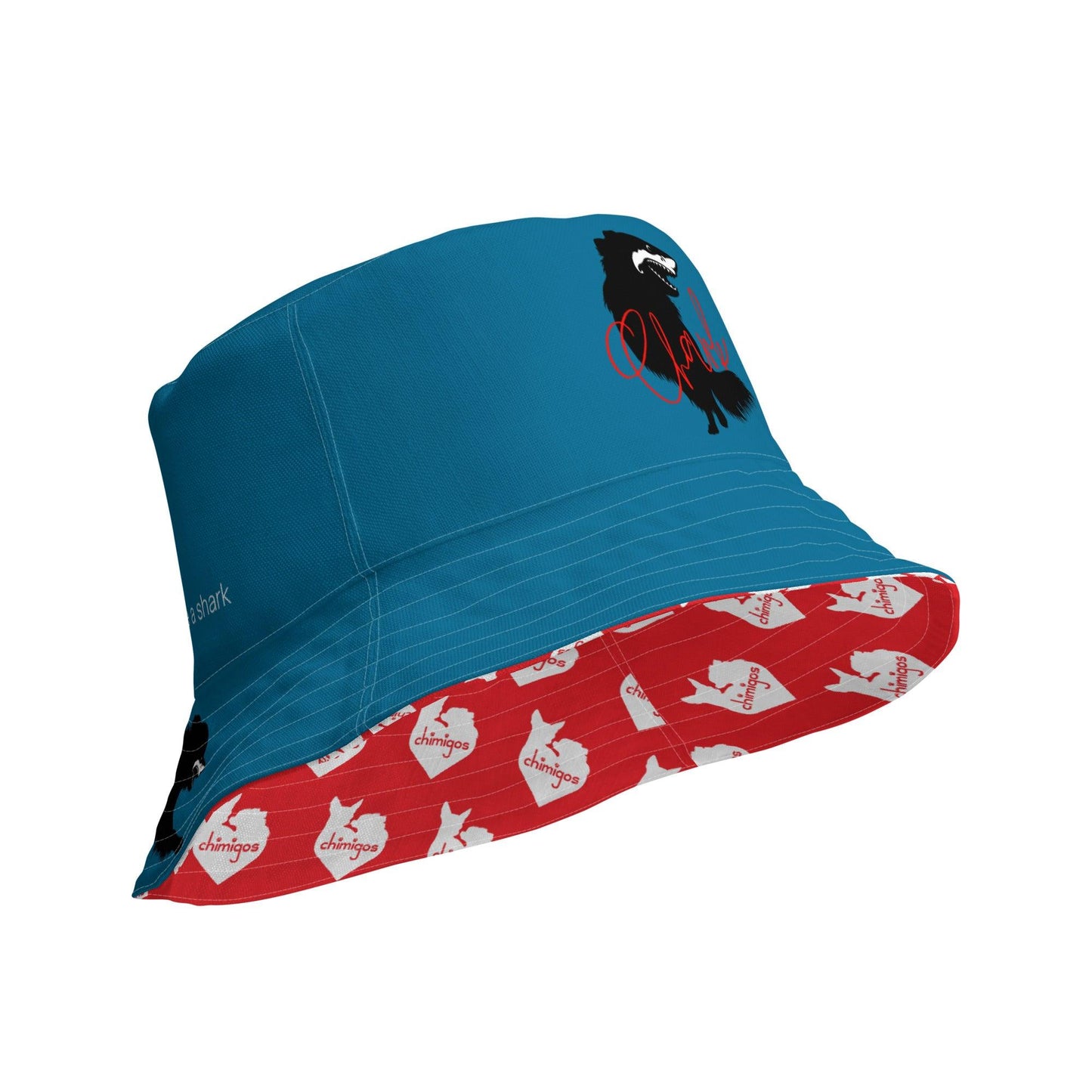 Chihuahua + Shark = Chark reversible bucket hat. Blue outer with black silhouette of a longhaired chihuahua with the face of a great white shark + "Chark" in red cursive font, and another shark-faced chihuahua silhouette running on the brim, below a dictionary entry of the noun "chark": a chihuahua with teeth like a shark. Red inner scattered with white cute love heart Chimigos logos. Unisex in two sizes. Design by Renate Kriegler, owner of Chimigos - for the love of chihuahuas. More on chimigos.com